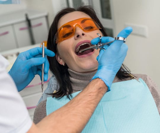 Dentist in Bellevue applying Local Anesthetic on the patient.